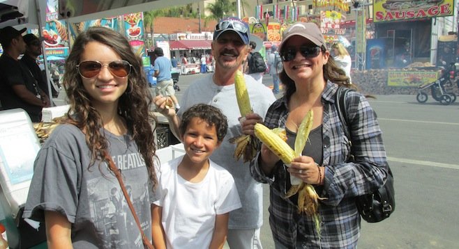 A family scores some corn near the front gate — only $4.17 an ear! Bargain!