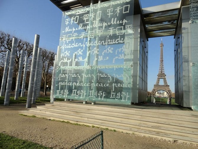 Paris: Wall for Peace. The word peace written in 32 different languages. Eiffel Tower in background