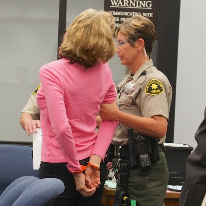 Donna led away in cuffs.