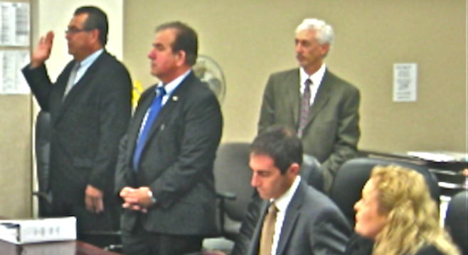 Greg Sandoval (far left) swore to tell the truth before pleading guilty on April 4.