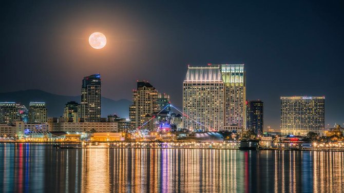 Full moon over downtown and the midway by Justin Brown.