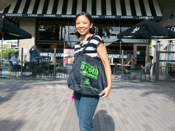 Model with Rise Above Plastics bag handed out free at UTC Mall in June 2014.