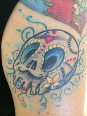 This is my sugar skull that Taylor from Taylored Tattoos (on park) tattooed on me. It represents my Mexican culture with bright fun colors, in a fun Tim-Burton style way. I live in Kensington, I am a behavior coach for foster youth and I am 27 years old. 