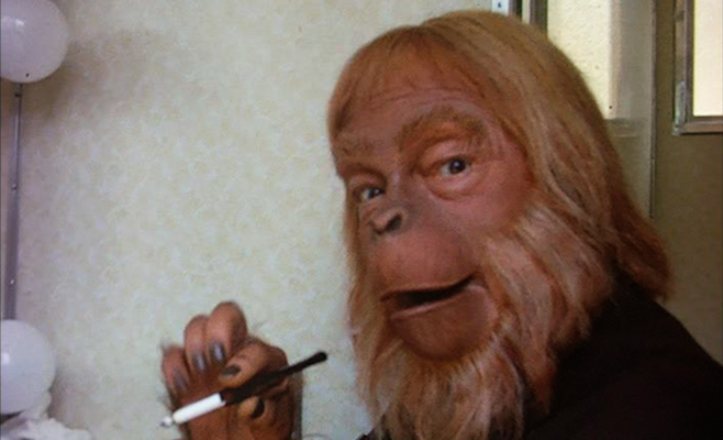 Maurice 'Dr. Zaius' Evans grabs a butt between takes during the filming of Planet of the Apes.