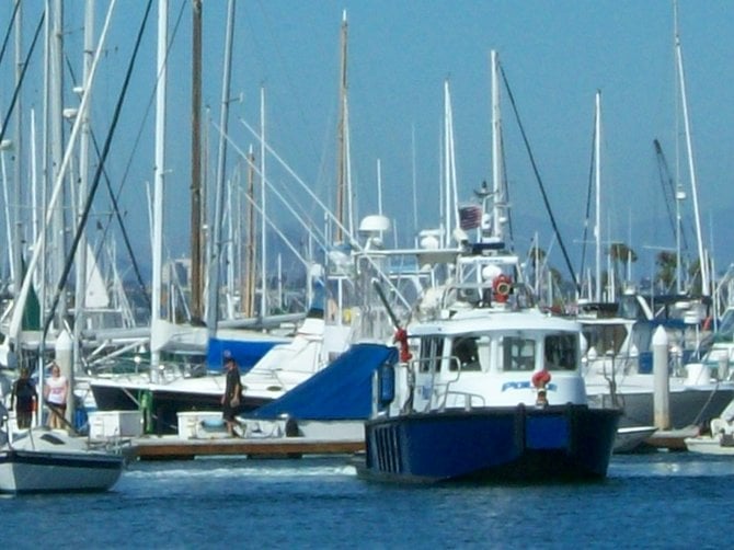 Small sailboat on the left was full of kids when the Police boat caught up to it.