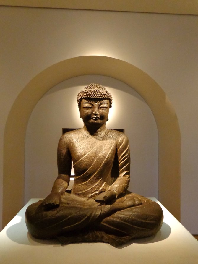 A statue of the Buddha in a museum in London.