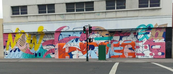 The constantly graffiti-tagged old empty F.W. Woolworth store on University Avenue in North Park now has some cool artwork. It fits in well, and I like it!