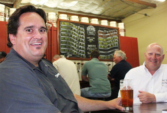Architect Dustin Hauck (left) enjoying a beer at a brewery he helped bring to fruition, Council Brewing Company in Kearny Mesa.