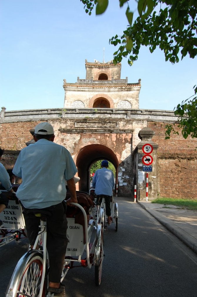 A caravan of cyclos brings visitors to Huế citadel -- it's the only way to fly!