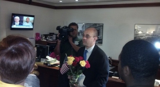 Faulconer staffer Felipe Monroig accepts the delegates' gifts