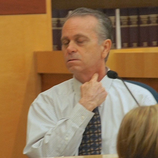 Greg Foley showed the jury how he put the knife to his own throat. Photo by Eva