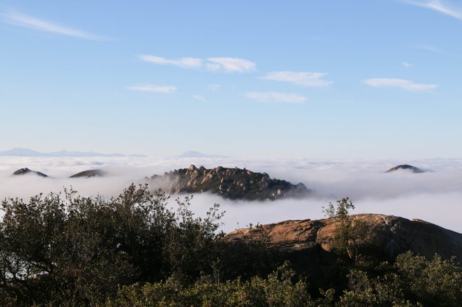 A sea of morning clouds covers the valley below Mt. Woodson.