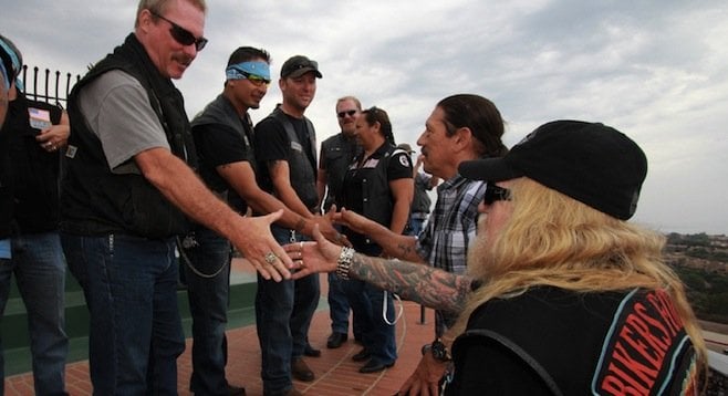 Pastor Z and Danny Trejo were greeted at the top of the stairs by veterans.