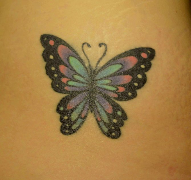 I'm Jen and this is my butterfly tattoo. Eno at Guru Tattoo in Pacific Beach did an excellent job with this cover up. He understood exactly what I wanted and made a big butterfly out of a smaller butterfly. It reminds me stain glass and I love the colors. 
