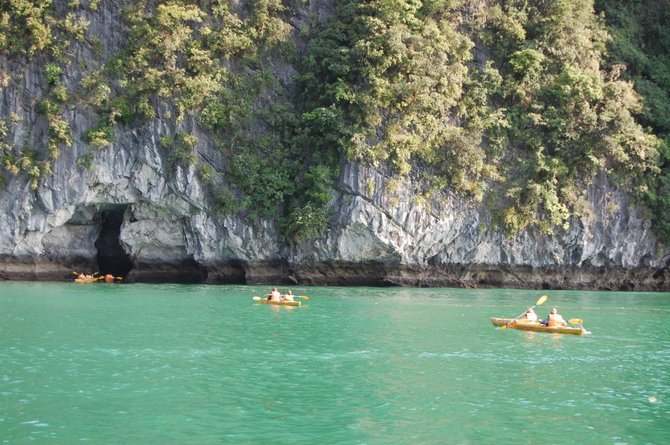 Kayakers explore Halong Bay.