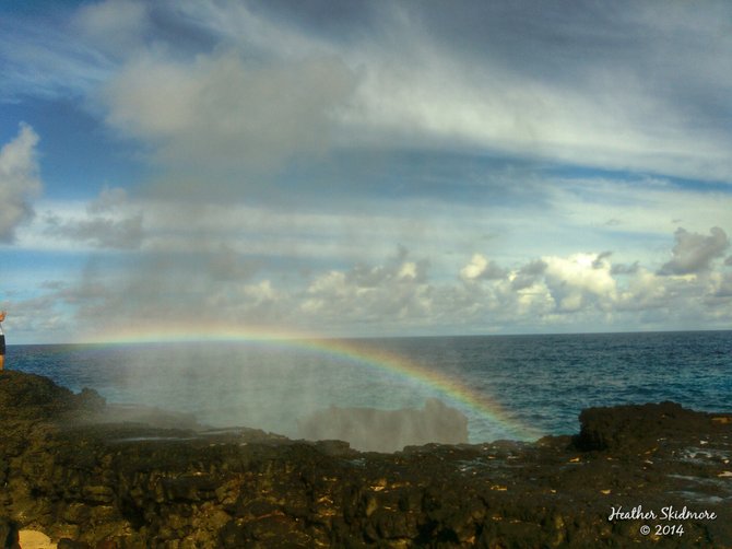 Rainbow appears as the waves crash against the rocks.
American Samoa