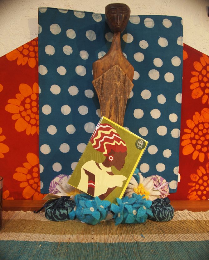 A Rwandan greeting card set against a back drop of handcrafted products at Fair Trade  Décor.