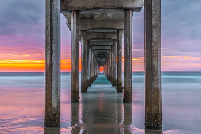 An immensely colorful sunset at Scripps Pier in La jolla, CA.