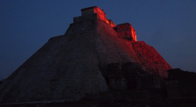 Uxmal's centerpiece, the Pyramid of the Magician, lit up at night. 