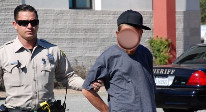 A sheriff's deputy takes a suspect into custody in Lemon Grove