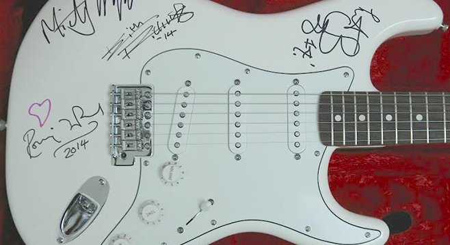 Stones-signed guitar. Start the bidding — at $36,000!