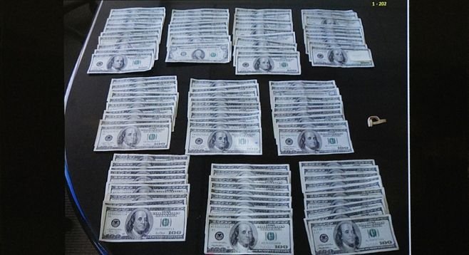 Evidence photo of some of the cash taken from the alleged get-away-bag. 