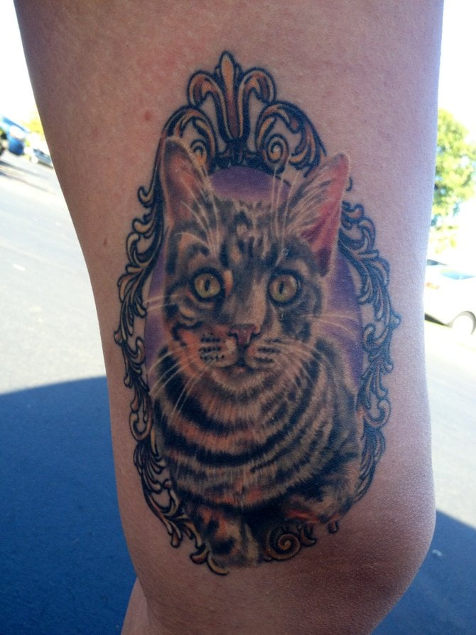 This is a portrait of my cat Tyga. It was made by Chad Whitson at Bearcat Tattoo Gallery in Little Italy. I am 26 years old and I work the front desk at Floyd's Barbershop in downtown San Diego in East Village.