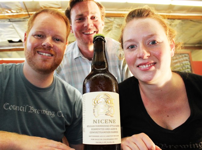 Council's Jeff Crane (background), Curtis and Liz Chism pose with a bottle of their first barrel-aged beer, Nicene  - Image by @sdbeernews