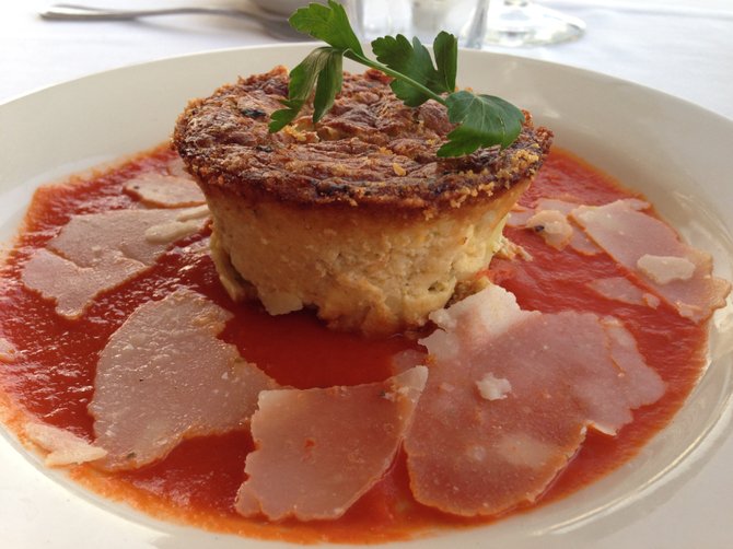 Delicious special item, artichoke soufflé with shaved Grana Padano and tomato coulis