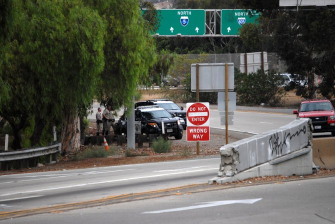 Police officers by the Camino De La Plaza exit.