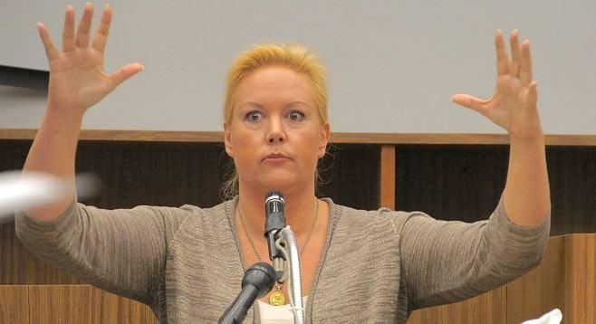 Julie Harper showed the jury how her husband came at her with arms raised.