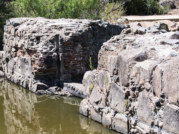 Brick and rock work are visible at the dam site.