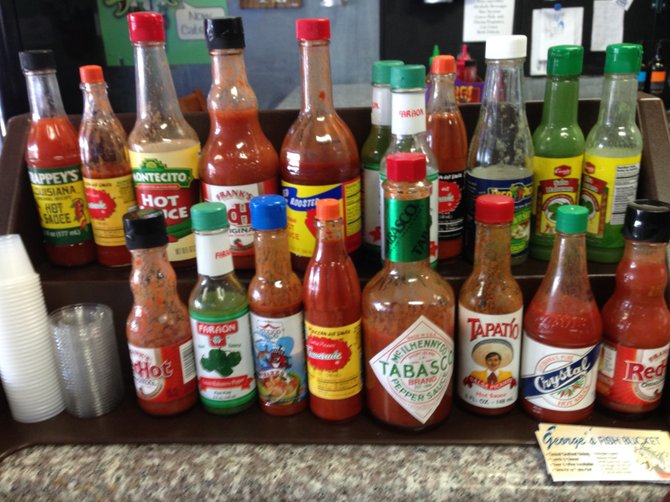 A parade of hot sauce to spice your fish.
