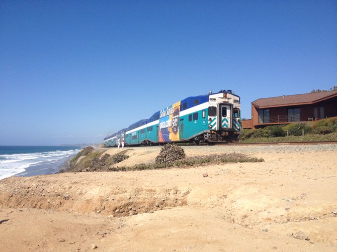 A train passes by the Del Mar surf spot on 11th Street.