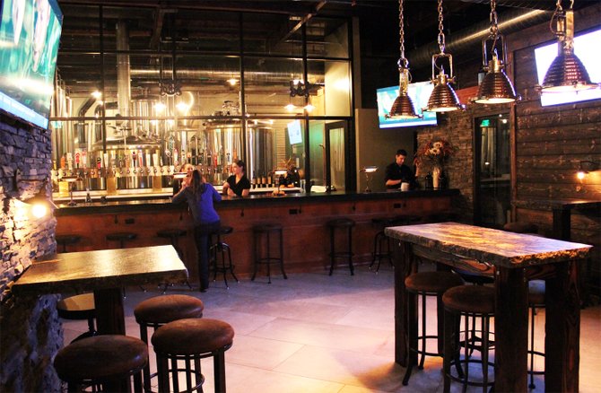 The tasting room at The Cork and Craft offers Abnormal Wine Company vino and a view of the upcoming Abnormal Beer Company brewhouse