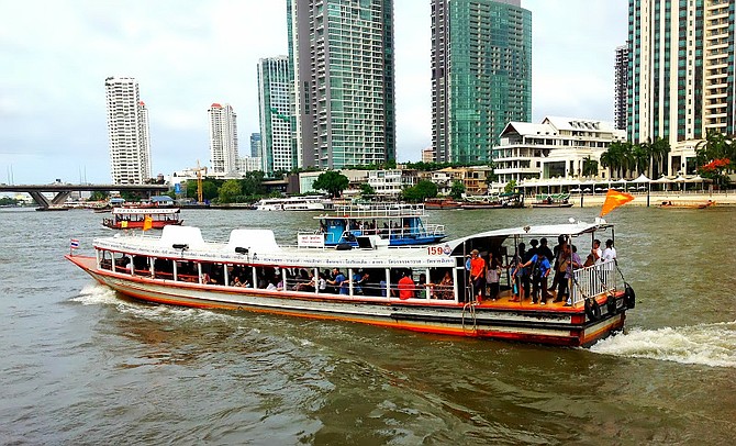 One of the river taxis transporting passengers along the snaking Chao Phraya river