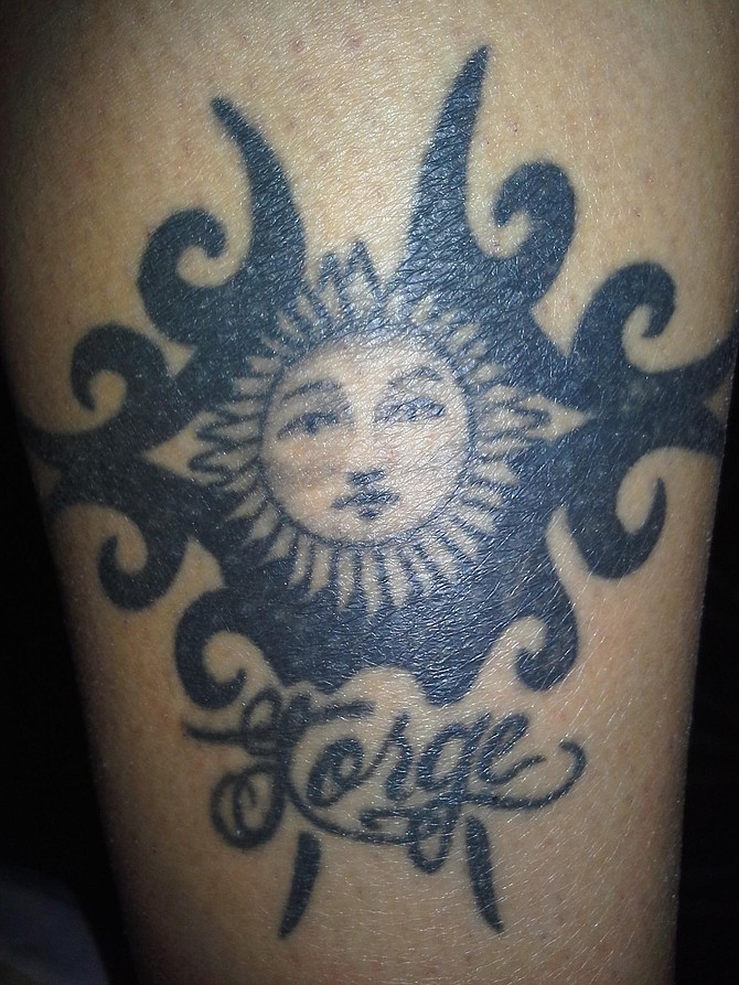 I got this tattoo because I love tribal and love the sun. I also added my husband's name underneath.  It was done at 1904 Studio on Adam's ave in San Diego. I live in Linda Vista and I am a Medical Assistant. 