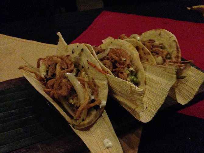 The winning tacos, served on corn husks despite being on flour tortillas. Sandbar Sports Bar & Grill.