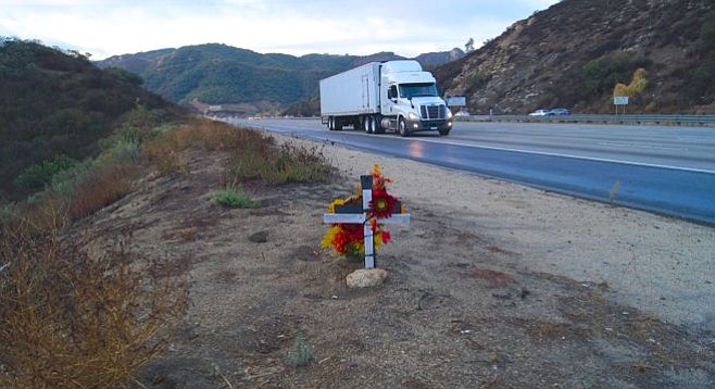 Memorial near the spot where two cars went over the edge off freeway 15. Photo by Weatherston