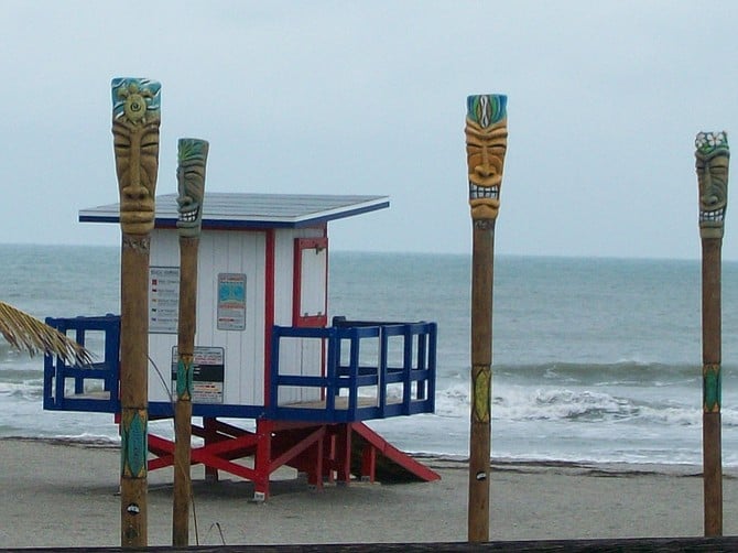 Tikis line the sand at Cocoa Beach, Florida.