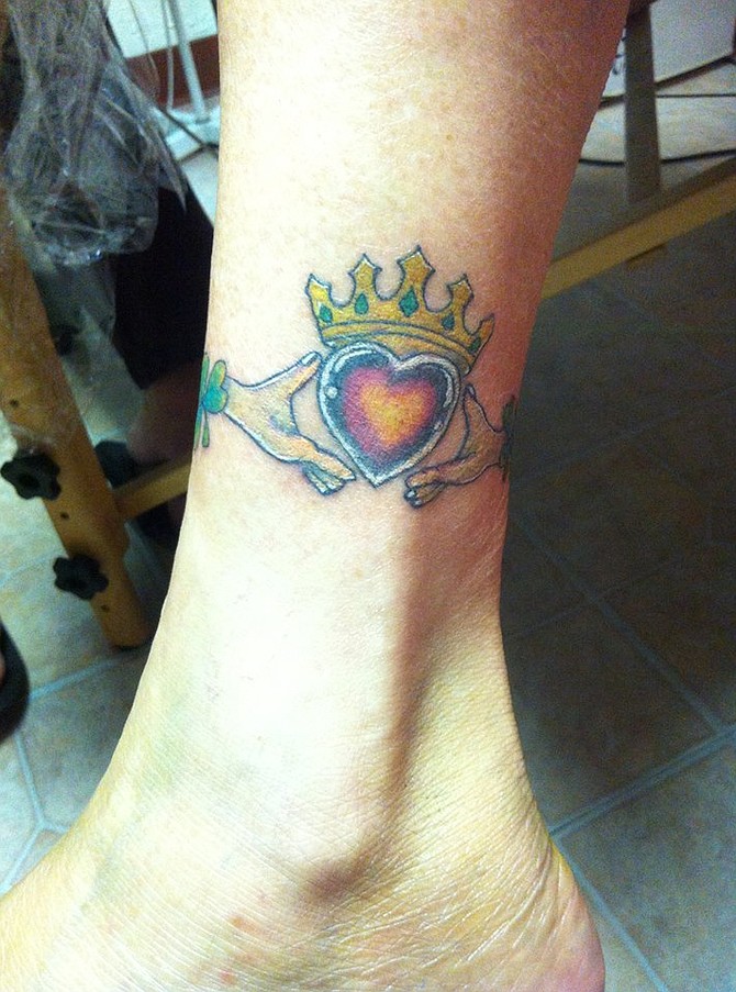 This was done 6 months after my husband of 42 years passed away, he was Irish, thus the claddagh.  It was done by Petko Mihailovich.  

Dale Crawford
2944 Slivkoff Dr
Escondido, CA  92027-4244

Homemaker

There is a Celtic knot on the other side of ankle and the shamrocks are between them.