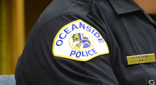 Oceanside police patch on officer's shoulder.