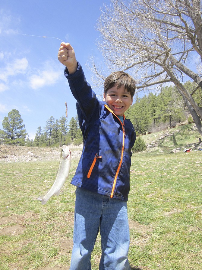 Elijah caught his first fish at 5 years old in Flagstaff, AZ. With help from Grandpa Bill and Uncle Lou to bait the worm on the hook. April 2014