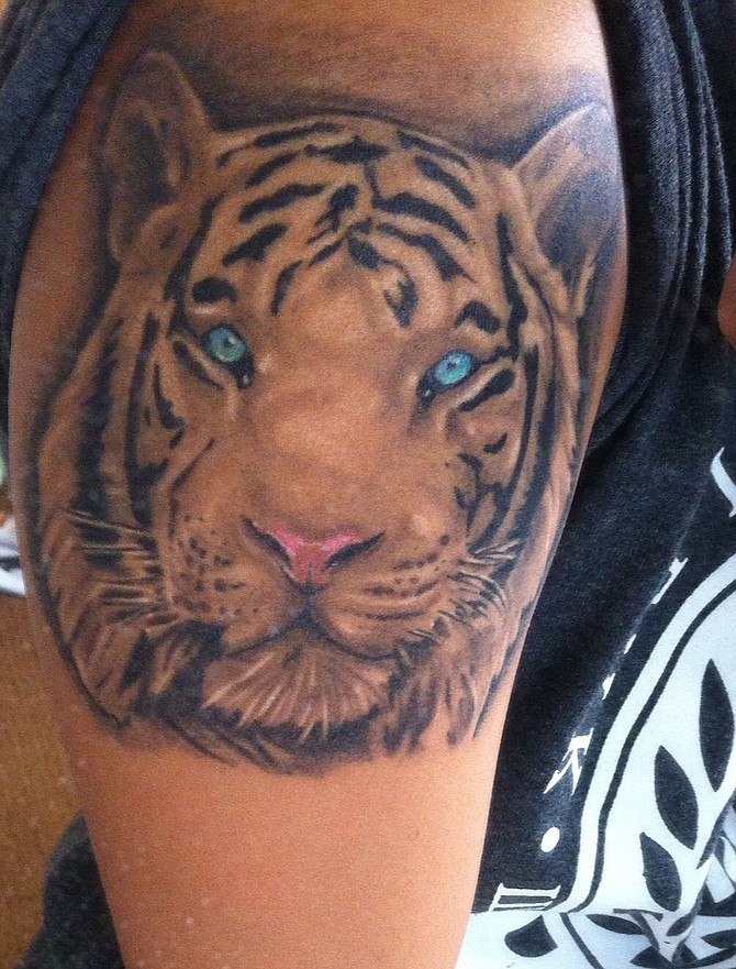I'm 19 years old and live in Chula Vista. I work as a professional dancer (contemporary/polynesian based) and am also a dance instructor. This is the start to my sleeve; a black & grey white tiger with focuses of color to highlight the most intense features of his face. 
I am in love with animals and this portrait expresses a little amount of my appreciation for them.
Best work I've had done so far! This one was done at Wylde Sydes Tattoo Shop by Jesus Sanchez. His work is amazing and he is continuing the rest of my art. 
