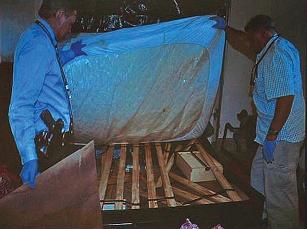 Police lifted a mattress and found a body hidden underneath.