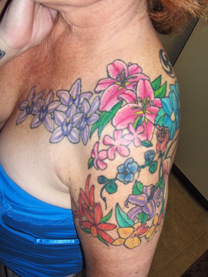 After a trip to Hawaii in 2005, I had this tattoo done by Heather Sinn at Avalon tattoo in Pacific Beach.  It represents all of the beautiful flowers so abundant on the island, and is a constant reminder of the trip.
Denise   52    Lakeside    Retired
