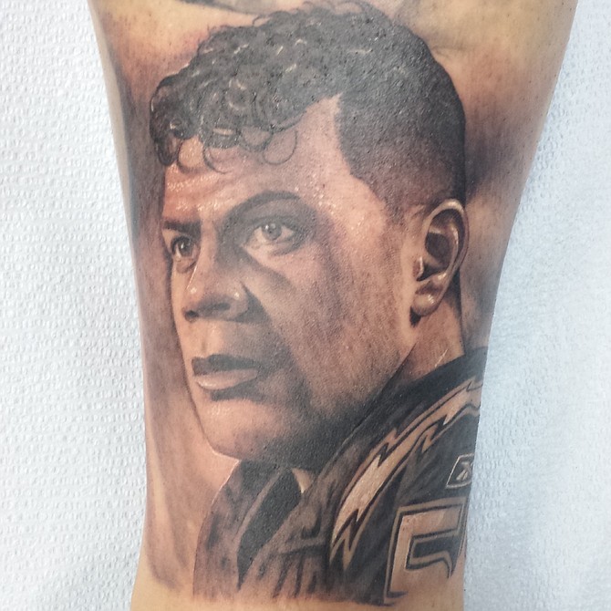 My name is Joseph, I'm an electrician for the city of San Diego. I've been a die hard Chargers fan all my life. My favorite player of all time is Junior Seau. Memorial tattoo done by Chuy Espinoza of Vital lines Tattoo located in Ocean Beach.