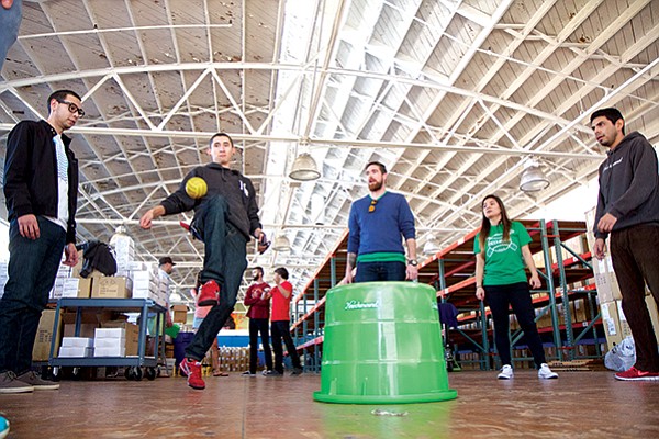 Employees playing in the Knockaround warehouse