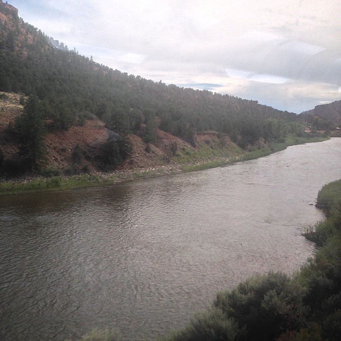Train window view of the Colorado River. 