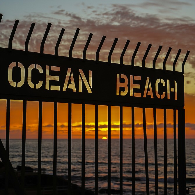 Sunset through the gate at OB Pier (Ocean Beach), San Diego, California 